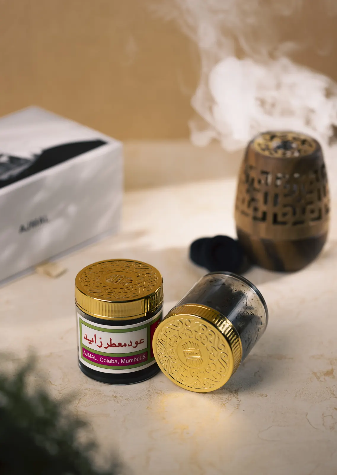 An Ajmal oud bottle, table-top photography